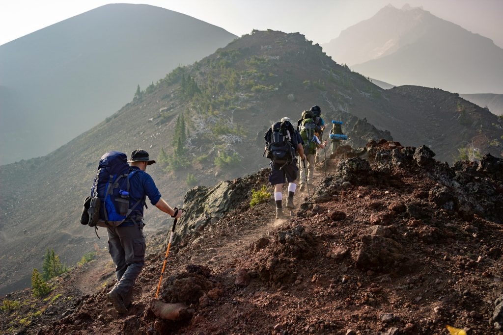 Hikers trekking through the dramatic landscape of the Rift Valley