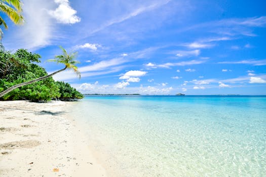 Stunning beach in Laamu Atoll, Maldives, with turquoise waters and clear skies.
